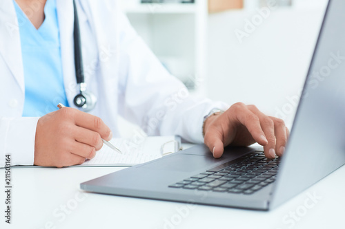 Male doctor, medical students or surgeon using laptop during the conference. Health Check with digital system support for patient, test results and data registration.