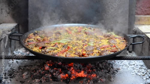 paella valenciana en españa cocinada a fuego photo