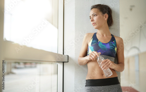 Fitness brunette girl relaxing after exercising