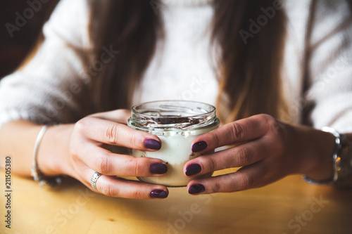 Girl holds glass of milk or yogurt. eating. Copy space. Breakfast  snack. Lifestyle concept