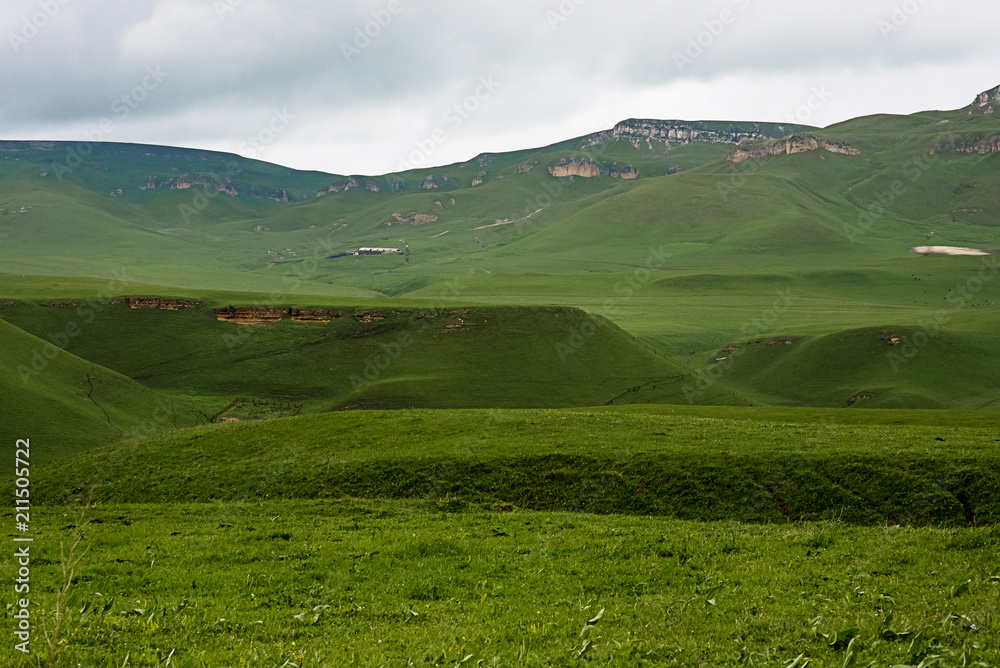 Baksan valley in the Caucasus mountains in Kabardino-Balkariya, Russia. Hills with green grass