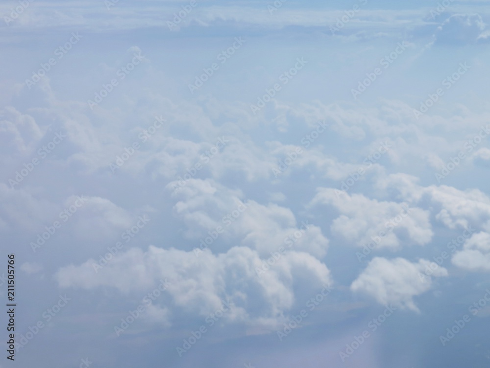 Tranquil Beautiful View From Plane Window at Blue Sky over White Clouds Tranquil Beautiful View From Plane Window at Blue Sky over White Clouds