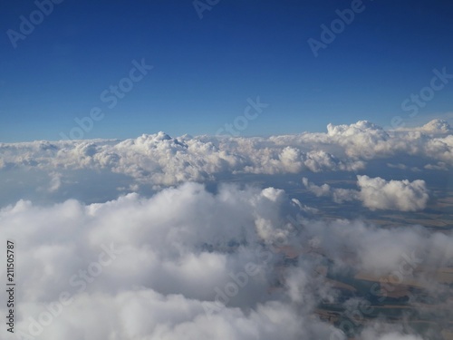 Tranquil Beautiful View From Plane Window at Blue Sky over White Clouds