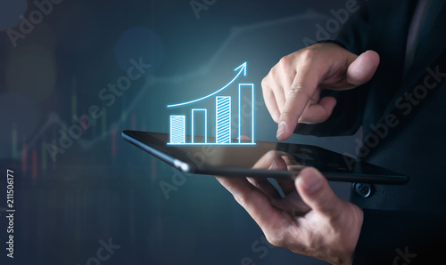Businessman holding tablet and have a chart showing business growth. positive indication of income.