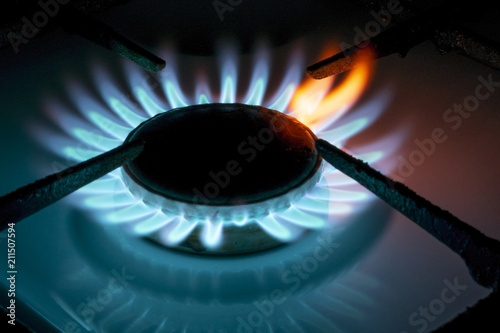 burning gas burner in the dark, close-up with a red flame tongue