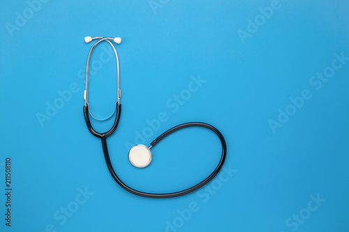 Flat lay aerial of tools medical & Healthcare insurance background concept.space for design.Table top view essential items for doctor using treat & care patient in hospital.Stethoscope on blue paper.