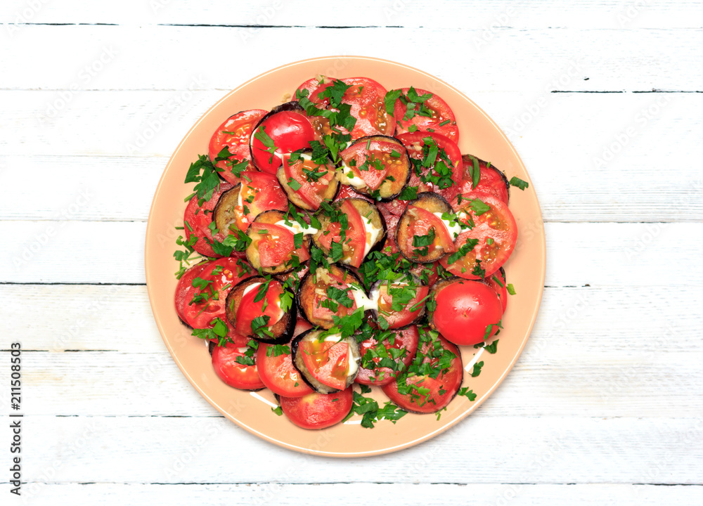 fried eggplant with tomatoes, garlic and mayonnaise on a white wooden background, top view close-up fried eggplant with tomatoes, garlic and mayonnaise on a white wooden background, top view close-up