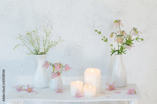 Fototapeta Naklejka Na Ścianę i Meble -  white vintage interior with flowers and candles