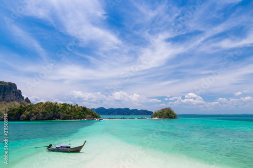 Thai long tail boats on the beach and tombolo with beautiful island, Krabi Phuket Thailand