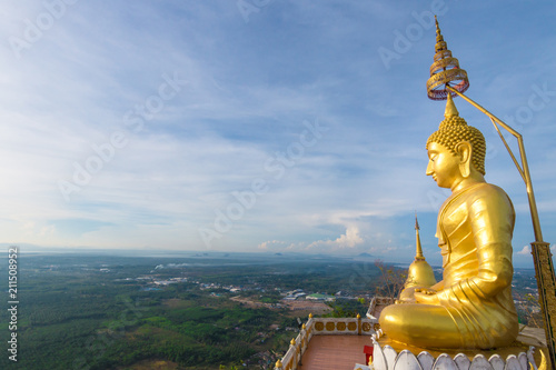 The golden Buddha at the top of mountain, Tiger Cave temple, Krabi Thailand.
