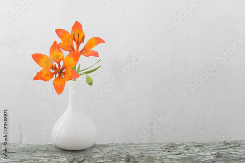 Fototapeta Naklejka Na Ścianę i Meble -  orange lily in vase on white background