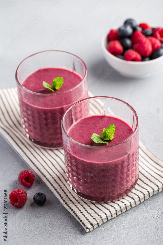 Mixed berry smoothie with mint on light concrete background Mixed berry smoothie with mint on light concrete background