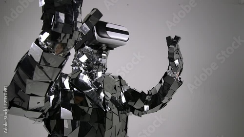 Futuristic Robot in mirror costume vorking with virtual interface, touching interface by index finger. photo