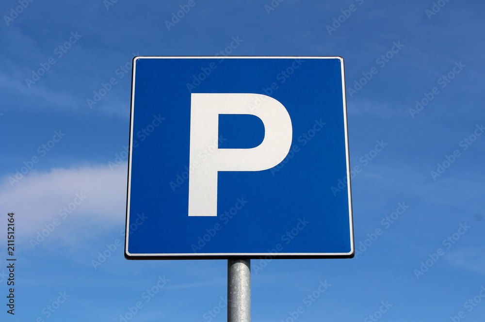 Parking sign with cloudy blue sky background on warm sunny day Parking sign with cloudy blue sky background on warm sunny day