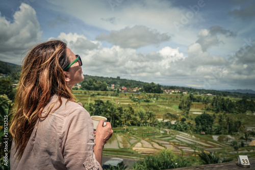 Woman with a cup of coffee near the rice terraces