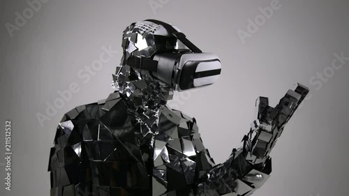 Futuristic Robot in mirror costume vorking with virtual interface, touching interface by index finger. photo