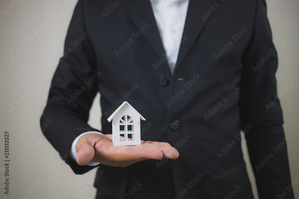 Businessman hand holding model white house. Property investment and house mortgage financial concept, Home protect, Insurance. With copy space for your text. Businessman hand holding model white house. Property investment and house mortgage financial concept, Home protect, Insurance. With copy space for your text.