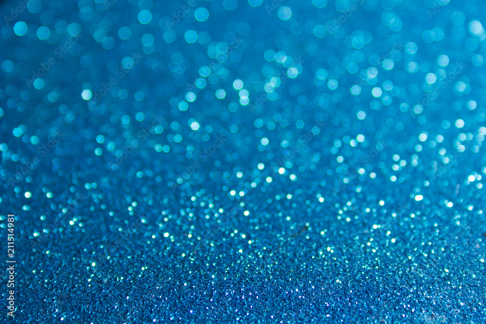 Closeup of glittery, blue, abstract surface. Shiny, rough texture glows in festive - holiday style Closeup of glittery, blue, abstract surface. Shiny, rough texture glows in festive - holiday style