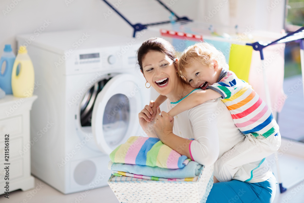 Family in laundry room with washing machine Family in laundry room with washing machine
