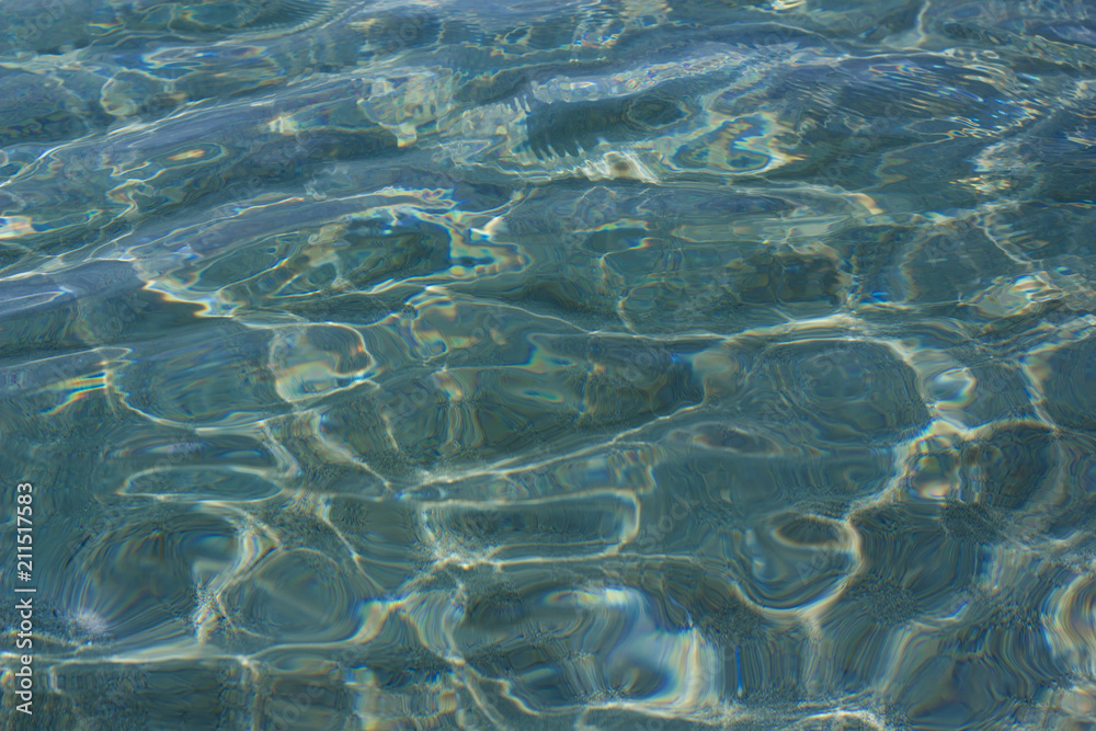 Beautiful caustics on water surface in blue sea Beautiful caustics on water surface in blue sea