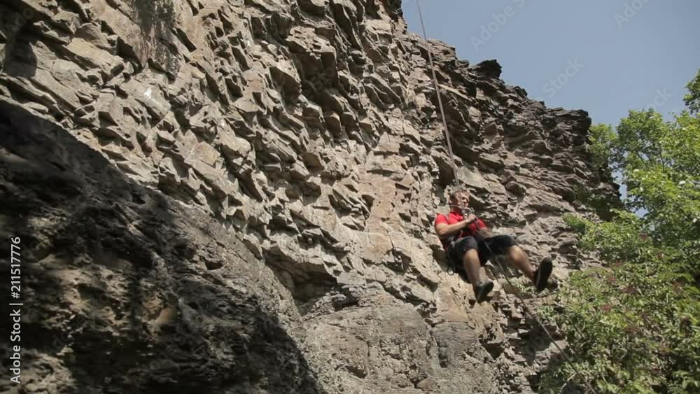 Young man on a rock climbing Young man on a rock climbing