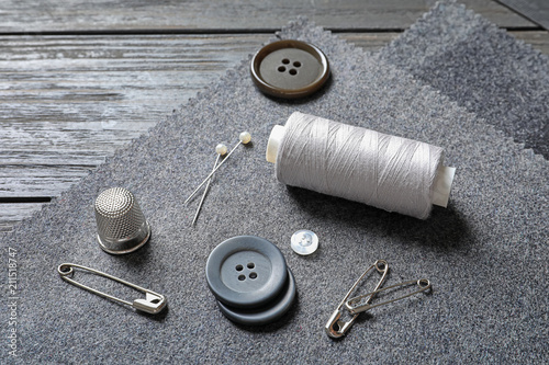 Set of tailoring accessories and fabric on table