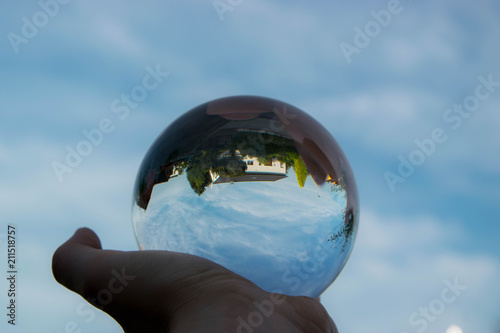 Glasssphere in a hand with a reflection