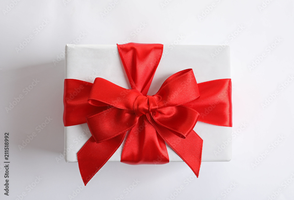 Beautifully wrapped gift box on white background, top view Beautifully wrapped gift box on white background, top view