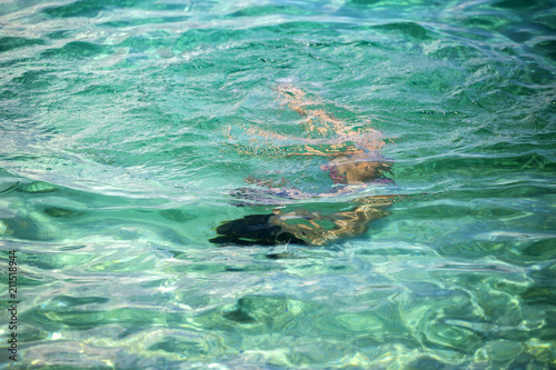 Little girl enjoying snorkeling in beautiful Croatian sea