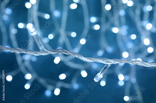 Beautiful Christmas lights on color background, closeup
