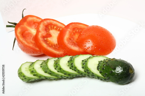 sliced tomato and cucumber on white background photo