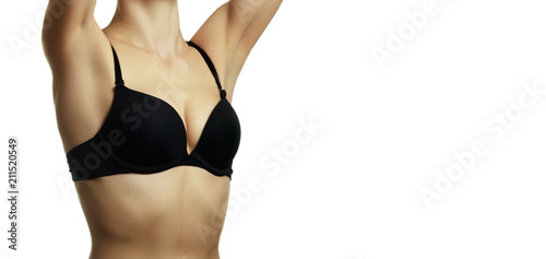 Closeup of a woman wearing a black bra isolated on white backgro