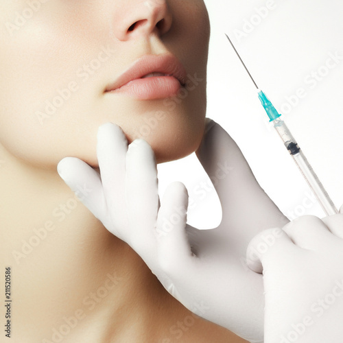 Portrait of young  woman getting cosmetic injection. Closeup of