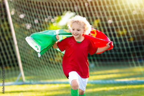 Portugal football fan kids. Children play soccer.