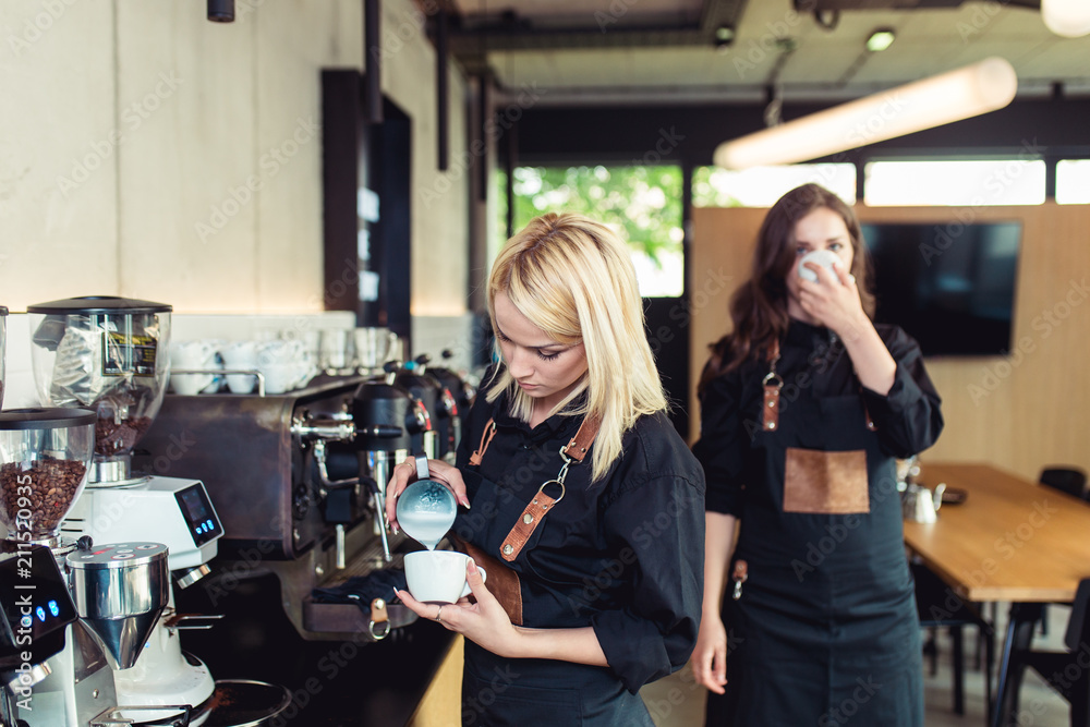 Procedure of making fresh coffee. Professional baristas pouring milk into cup of espresso coffee. Procedure of making fresh coffee. Professional baristas pouring milk into cup of espresso coffee.