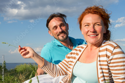 happy couple in love at a picnic. Romantic concept at the beach. Cheerful couple having fun on summer vacation © ReyRomMedia