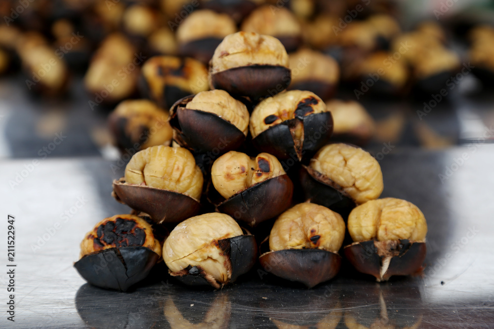 Fried chestnuts on the street. Street food. Roasted chestnuts Fried chestnuts on the street. Street food. Roasted chestnuts