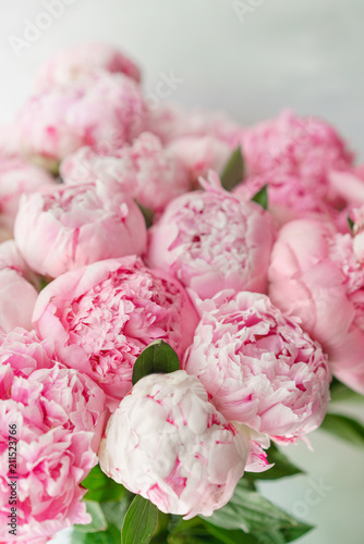 Beautiful bouquet of pink peonies . Floral composition, daylight. Wallpaper. Lovely flowers in glass vase.