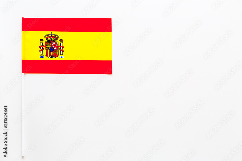 Spanish flag concept. Small flag on white background top view copy space