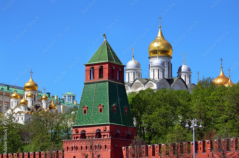 Cathedrals  of Moscow Kremlin behind  red kremlin wall