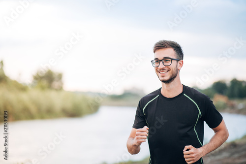Young Man Running By the River