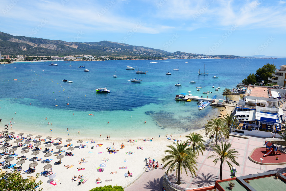 The tourists enjoiying their vacation on the beach, Mallorca, Spain