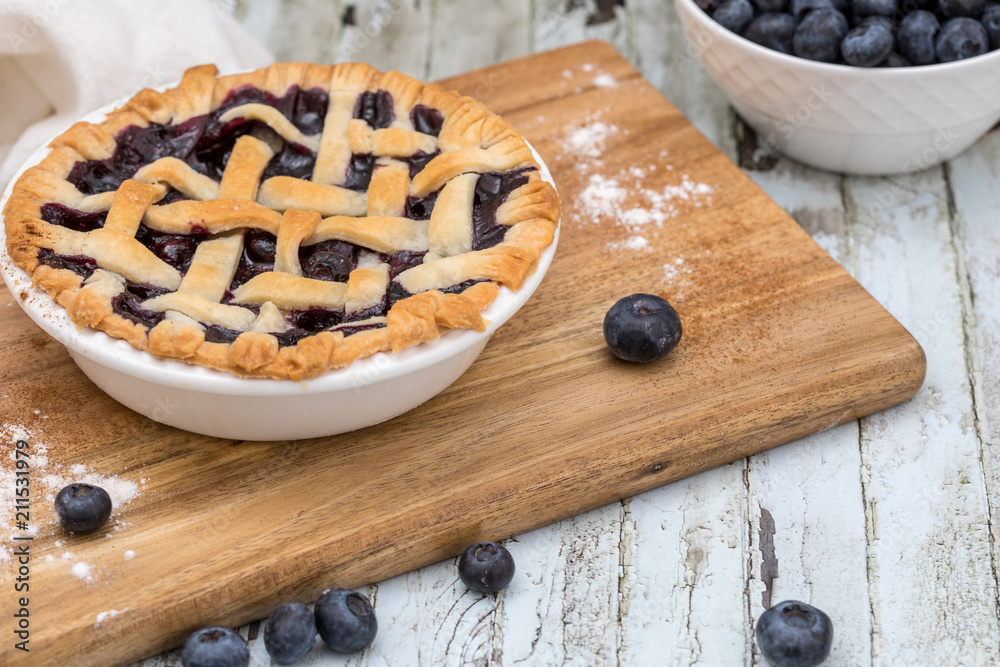 Homemade small individual blueberry pies with fresh summer blueberries