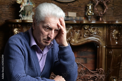 Portrait of sad senior man posing  photo