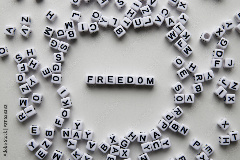 freedom word written on cubes on white background. Creative text for your business. Chaotic letters design