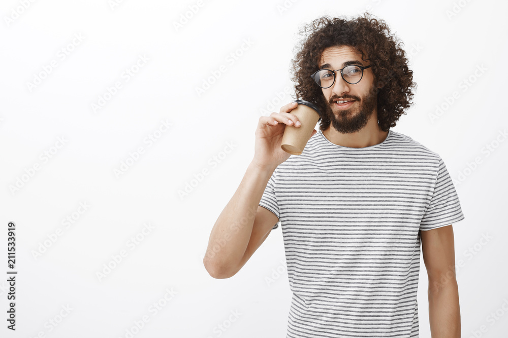 Portrait of confident good-looking slim male barista in trendy t-shirt and eyewear, drinking coffee from cup and gazing at camera, having break and enjoying perfect evening with friends in cafe Portrait of confident good-looking slim male barista in trendy t-shirt and eyewear, drinking coffee from cup and gazing at camera, having break and enjoying perfect evening with friends in cafe