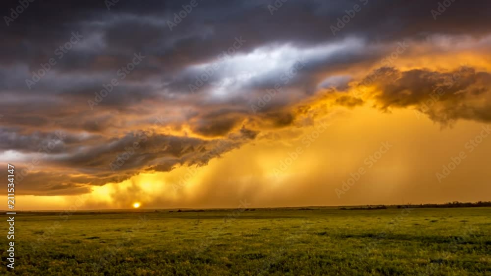 Suring sunset in the Great Plains in Tornado Alley, a storm moves ...