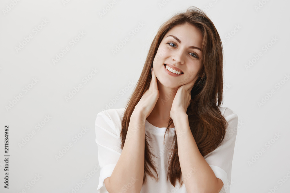 She wants boyfriend to make her massage. Portrait of charming caucasian girl tilting and smiling broadly while touching neck with hands, feeling tired after long day working on project, wanting rest She wants boyfriend to make her massage. Portrait of charming caucasian girl tilting and smiling broadly while touching neck with hands, feeling tired after long day working on project, wanting rest