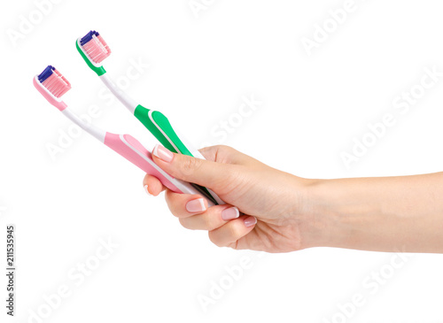 Two toothbrushes in hand on white background isolation