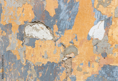 yellow and blue paint peeling off wall background